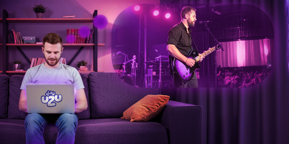 A MAN OF AROUND 25 YEARS OLD, WHO IS PLAYING, PLAYING ON A COMPUTER IN PLAYUZU AND IS SITTING ON A SOFA, WHILE HE IS DREAMING THAT HE IS PLAYING THE GUITAR ON A STAGE FULL OF EMOTION
